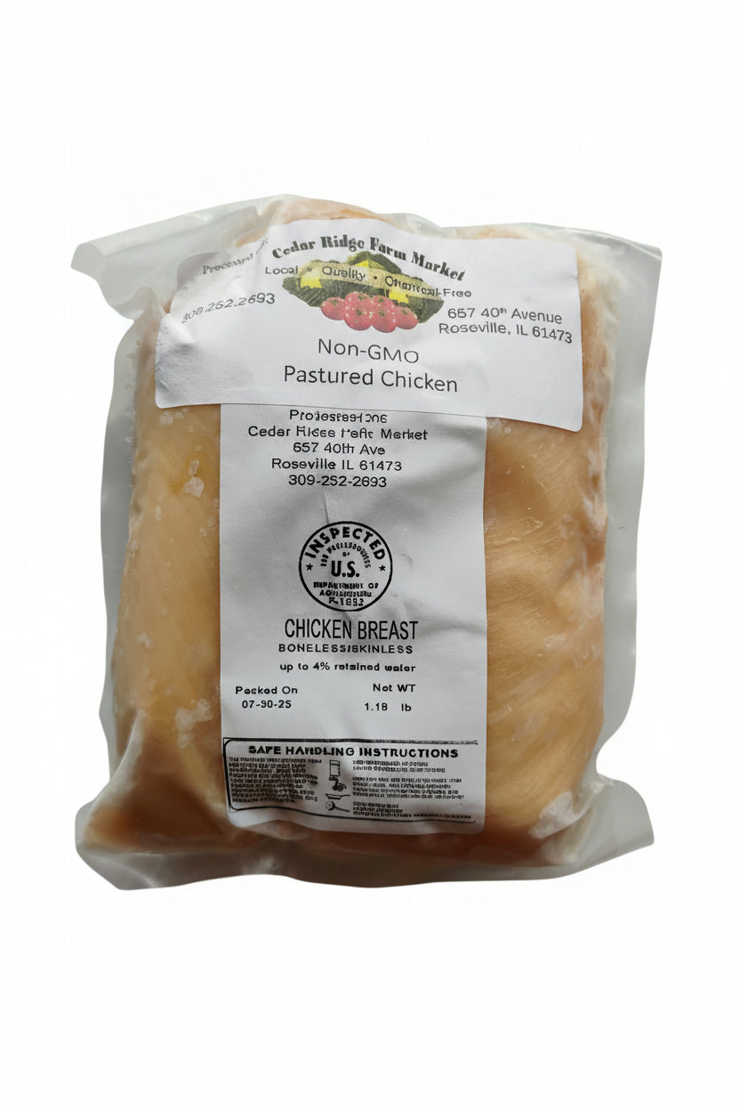 Packaged chicken breast with a label on a white background