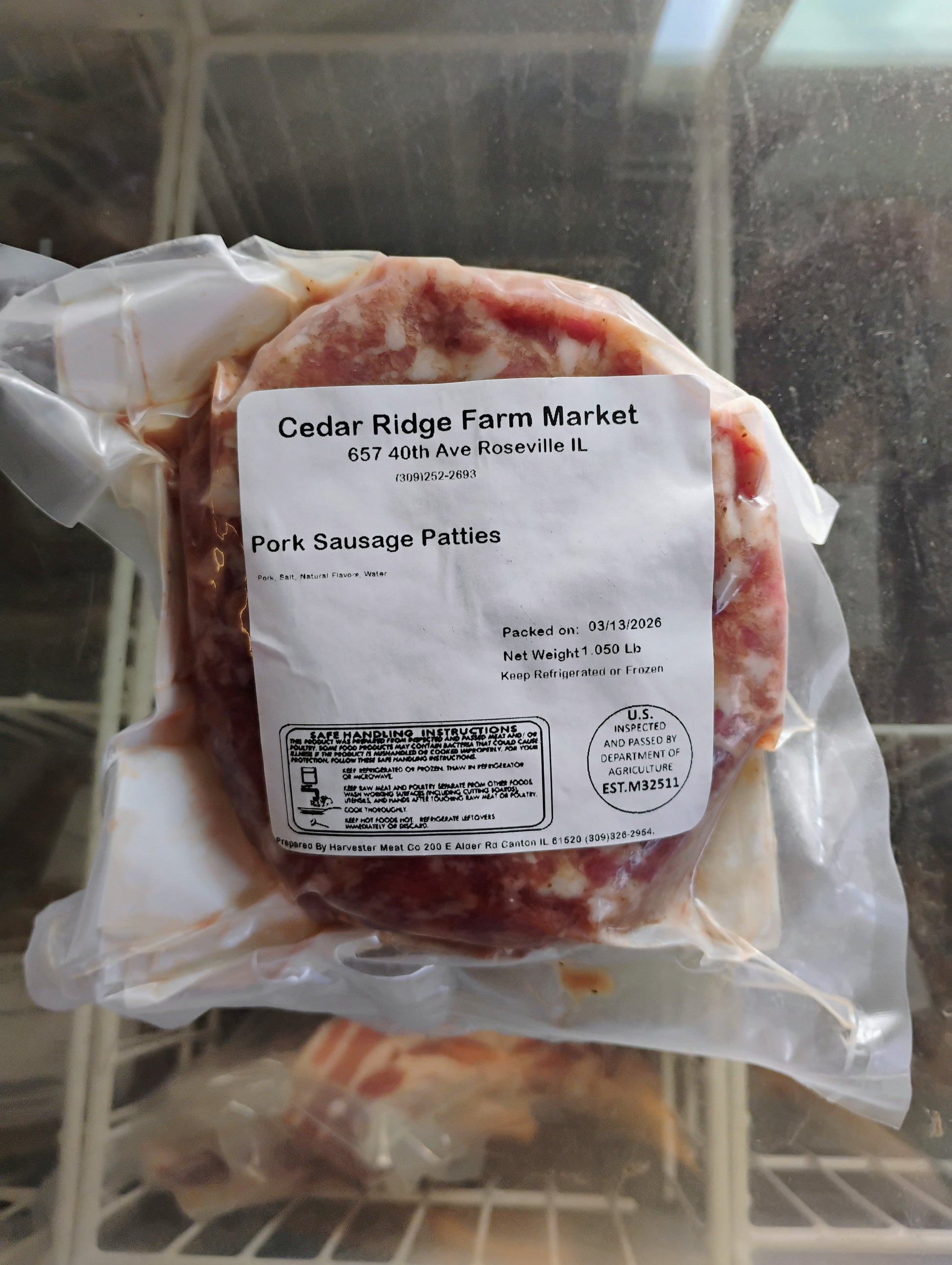 Packaged pork sausage patties with a label in a cooler