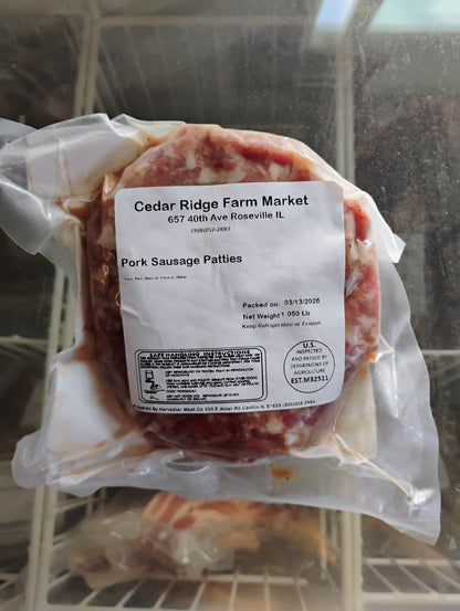 Packaged pork sausage patties with a label in a cooler