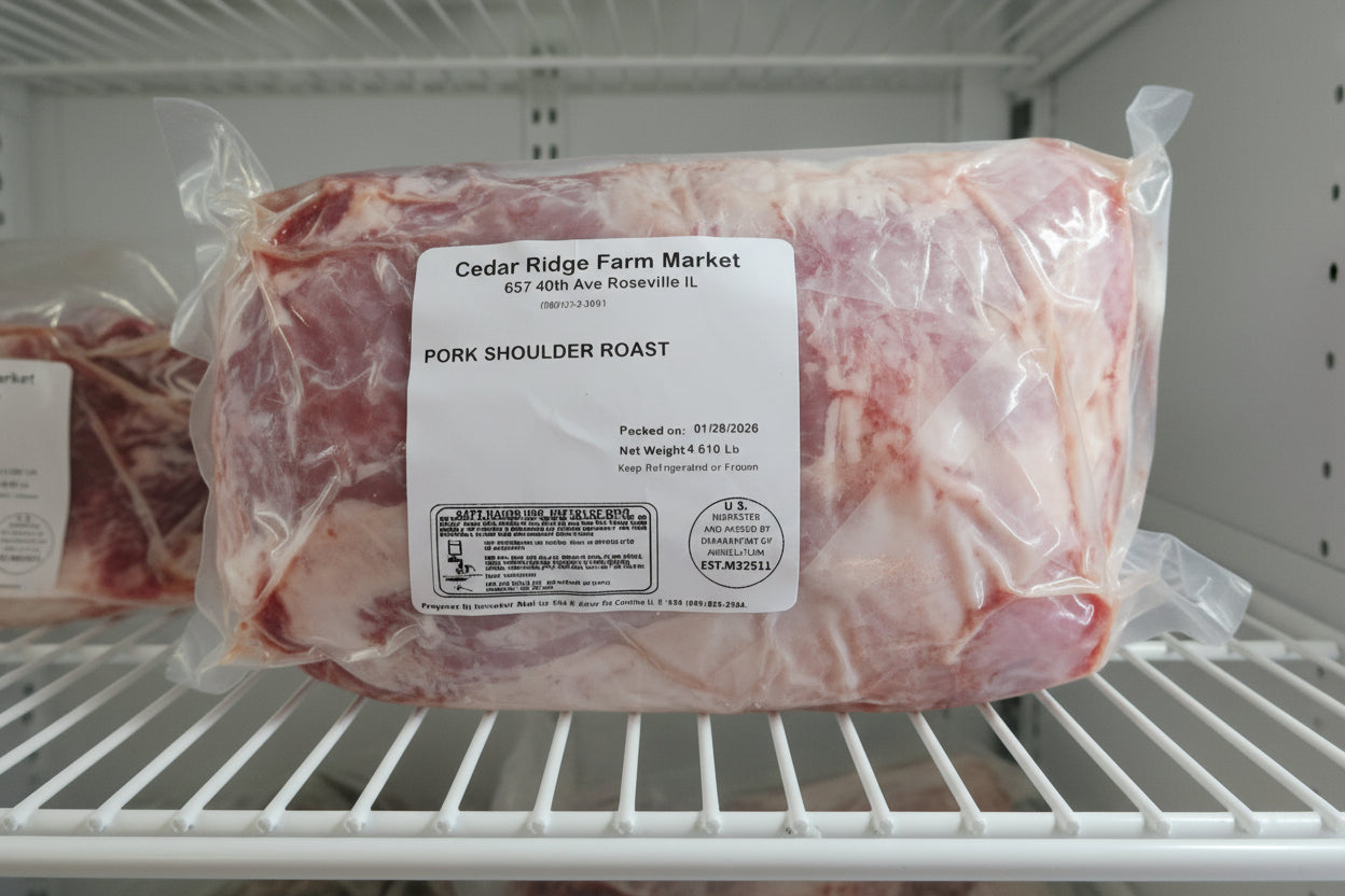Packaged pork shoulder roast from Cedar Ridge Farm Market in a refrigerator.