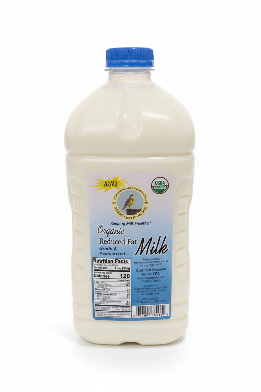 Large container of organic reduced fat milk with a blue cap on a white surface.