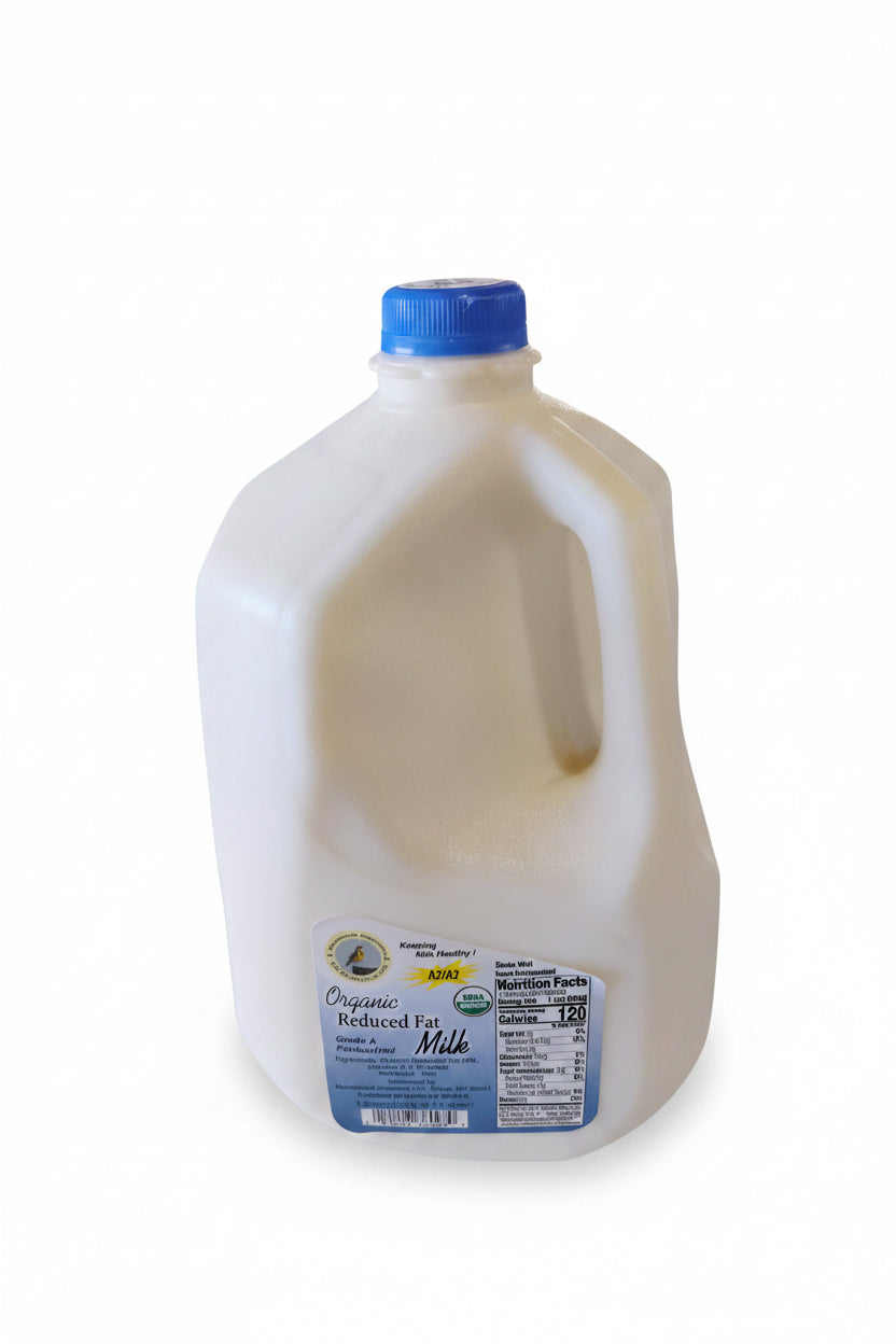 Jug of milk with a blue cap on a white surface, blurred background