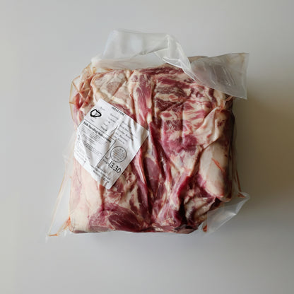 Packaged pork belly with a label on a white background